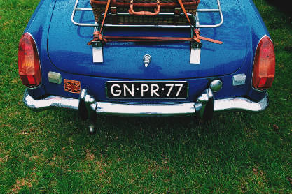 vintage-car-with-suitcase-on-boot-rack